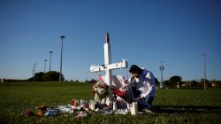 Joe Zevuloni mourns in front of a cross placed in a park to commemorate the victims of the shooting at Marjory Stoneman Douglas High School, in Parkland, Florida, U.S., February 16, 2018. REUTERS/Carlos Garcia Rawlins