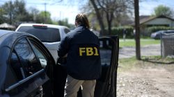 An FBI agent exits her car after arriving at the scene of an explosion near north Galindo street. Police investigators are at the home where a 17-year-old boy was killed and a woman injured in a package bomb explosion in Austin, Texas, U.S., March 12, 2018. REUTERS/Sergio Flo