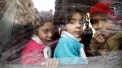 Children look through a bus window during evacuation from the besieged town of Douma, Eastern Ghouta, in Damascus, Syria March 13, 2018. REUTERS/Bassam Khabieh