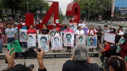 FILE PHOTO: Relatives pose with images of some of the 43 missing Ayotzinapa College Raul Isidro Burgos students in front of a monument of the number 43, during a march to mark the 41st month since their disappearance in the state of Guerrero, in Mexico City, Mexico February 26, 2018. REUTERS/Henry Romero