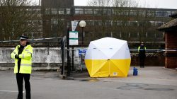 FILE PHOTO: Police officers stand behind a cordon placed around a payment machine covered by a tent in a supermarket car park near to where former Russian intelligence agent Sergei Skripal and his daughter Yulia were found poisoned in Salisbury, Britain, March 13, 2018. REUTERS/Henry Nicholls