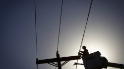 An electrical line technician works on restoring power in Vilonia, Arkansas April 29, 2014. REUTERS/Carlo Alle