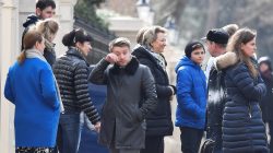 Embassy staff react as colleagues and children board buses outside Russia's Embassy in London, Britain,