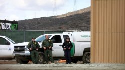 FILE PHOTO: U.S. border patrol officers are pictured near a prototype for U.S. President Donald Trump's border wall with Mexico, behind the current border fence in this picture taken from the Mexican side of the border in Tijuana, Mexico