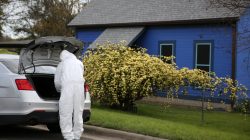 A law enforcement member is seen down the street from the home where Austin serial bomber Mark Anthony Conditt lived in Pflugerville, Texas, U.S., March 22, 2018. REUTERS/Loren Elliott
