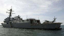 FILE PHOTO: The warship USS Mustin sails near the port in Sihanoukville, 223 km (139 miles) west of Phnom Penh, October 11, 2008. REUTERS/Stringer