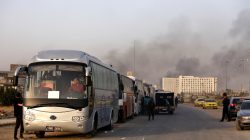 A convoy of buses that carry rebels and their families waits at Harasta highway outside Jobar, in Damascus, Syria March 26, 2018. REUTERS/Omar Sanadiki
