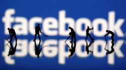 Figurines are seen in front of the Facebook logo in this illustration taken March 20, 2018. REUTERS/Dado Ruvic