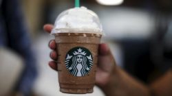 FILE PHOTO - A woman holds a Frappuccino at a Starbucks store inside the Tom Bradley terminal at LAX airport in Los Angeles, California, United States, October 27, 2015. REUTERS/Lucy Nicholson