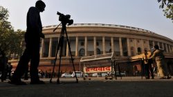 FILE PHOTO: Television journalists report from the premises of India's Parliament in New Delhi, India, February 13, 2014. REUTERS/Adnan Abidi/File Photo