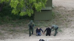 Border patrol agents apprehend people who illegally crossed the border from Mexico into the U.S. in the Rio Grande Valley sector, near Falfurrias, Texas, U.S., April 4, 2018. REUTERS/Loren Elliott