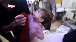 A child cries as they have their face wiped following alleged chemical weapons attack, in what is said to be Douma, Syria in this still image from video obtained by Reuters on April 8, 2018. White Helmets/Reuters TV via REUTERS