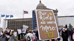 FILE PHOTO: Teachers rally outside the state Capitol for the second day of a teacher walkout to demand higher pay and more funding for education in Oklahoma City, Oklahoma, U.S., April 3, 2018. REUTERS/Nick Oxford/File Photo
