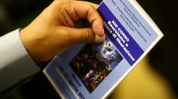 A priest holds a leaflet advertising a course for aspiring exorcists in Rome, Italy April 16, 2018. REUTERS/Tony Gentile