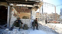 Members of Syrian police sit at a damaged building at the city of Douma, Damascus, Syria April 16, 2018. REUTERS/Ali Hashish