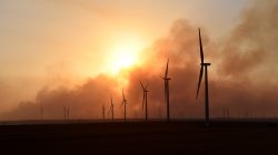 The sun sets through smoke from the Rhea fire on a wind farm near Seiling, Oklahoma, U.S. April 17, 2018. REUTERS/Nick Oxford