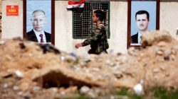 FILE PHOTO: A Syrian soldier loyal to President Bashar al Assad is seen outside eastern Ghouta, in Damascus, Syria February 28, 2018. To match Special Report RUSSIA-FLIGHTS/ REUTERS/Omar Sanadiki/File Photo