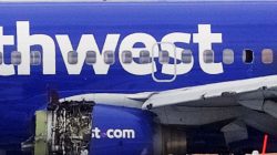 Emergency personnel monitor the damaged engine of Southwest Airlines Flight 1380, which diverted to Philadelphia International Airport after the engine blew apart and shattered a window, killing one passenger, on a runway in Philadelphia, Pennsylvania, April 17, 2018. REUTERS/Mark Makela