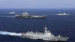FILE PHOTO - China's aircraft carrier Liaoning (C) takes part in a military drill of Chinese People's Liberation Army (PLA) Navy in the western Pacific Ocean, April 18, 2018. Picture taken April 18, 2018. REUTERS/Stringer