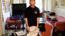 Carlos Alzaibar takes documents as he packs his suitcase at his home in Caracas, Venezuela March 14, 2018. REUTERS/Marco Bello
