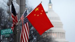 FILE PHOTO: The People's Republic of China flag and the U.S. Stars and Stripes fly on a lamp post along Pennsylvania Avenue near the U.S. Capitol during Chinese President Hu Jintao's state visit, in Washington, D.C.,U.S., January 18, 2011. REUTERS/Hyungwon Kang/File Photo