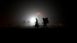 FILE PHOTO: A group of migrants who said they were from Djibouti and Somalia walk along railway tracks after crossing the Canada-U.S. border in Emerson, Manitoba, Canada, March 27, 2017. REUTERS/Chris Wattie/File Photo
