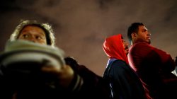People traveling with a caravan of migrants from Central America line up for eat at a camp near the San Ysidro checkpoint, after U.S. border authorities allowed the first small group of women and children entry from Mexico on Monday night, in Tijuana, Mexico May 1, 2018. REUTERS/Edgard Garrido