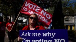 Pro-Life campaigner Vicky Wall holds a poster ahead of a 25th May referendum on abortion law, in Wicklow, Ireland, May 8, 2018. Picture taken May 8, 2018. REUTERS/Clodagh Kilcoyne