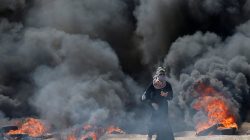 A female Palestinian demonstrator gestures during a protest against U.S. embassy move to Jerusalem and ahead of the 70th anniversary of Nakba, at the Israel-Gaza border, east of Gaza City May 14, 2018. REUTERS/Mohammed Salem