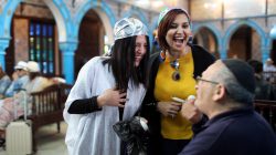 Two Tunisian Muslim women chat with a Jewish man at Ghriba, the oldest Jewish synagogue in Africa, during an annual pilgrimage in Djerba, Tunisia May 2, 2018. Picture taken May 2, 2018. REUTERS/Ahmed Jadallah