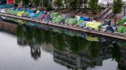 Tents where migrants live in a makeshift camp are seen on the Quai de Valmy of the canal Saint-Martin in Paris, France, May 15, 2018. Picture taken May 15, 2018. REUTERS/Philippe Wojazer