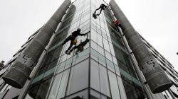 FILE PHOTO: Window cleaners work outside the offices of Cambridge Analytica in central London, Britain, March 24, 2018. REUTERS/Peter Nicholls/File Pho