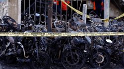 FILE PHOTO: Burned motorcycles are seen outside a church, one of the three hit by suicide bombers in Surabaya, Indonesia May 13, 2018. REUTERS/Beawiharta