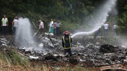 Firefighters work in the wreckage of a Boeing 737 plane that crashed in the agricultural area of Boyeros, around 20 km (12 miles) south of Havana, shortly after taking off from Havana's main airport in Cuba, May 18, 2018. REUTERS/Alexandre Meneghini