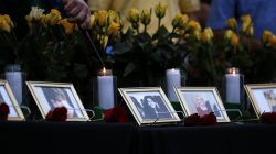 Candles are lit behind images of the victims killed in a shooting at Santa Fe High School during a vigil in League City, Texas, U.S., May 20, 2018. REUTERS/Jonathan Bachman NO RESALES. NO ARCHIVES.