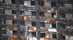 FILE PHOTO: Workers stand inside the burnt out remains of the Grenfell tower in London, Britain, October 16, 2017. REUTERS/Hannah Mckay/File Photo