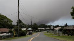 A volcanic ash cloud hovers in the distance over the small town of Pahala during the eruption of the Kilauea Volcano in Pahala, Hawaii, U.S., May 23, 2018. REUTERS/Marco Garcia