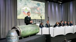 Dutch police officer Wilbert Paulissen, head of the National Crime Squad, is pictured next to a damaged missile as he presents interim results in the ongoing investigation of the 2014 MH17 crash that killed 298 people over eastern Ukraine, during a news conference by members of the Joint Investigation Team, comprising the authorities from Australia, Belgium, Malaysia, the Netherlands and Ukraine, in Bunnik, Netherlands, May 24, 2018. REUTERS/Francois Lenoir