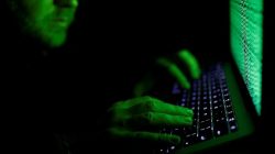 FILE PHOTO: A man types on a computer keyboard in front of the displayed cyber code in this illustration picture taken on March 1, 2017. REUTERS/Kacper Pempel/Illustration