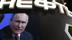 Russian President Vladimir Putin is seen on a screen at the stand of Russian state oil major Rosneft during the St. Petersburg International Economic Forum (SPIEF), Russia May 25, 2018. REUTERS/Sergei Karpukhin