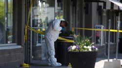 A police forensic investigator photographs evidence at Bombay Bhel restaurant, where two unidentified men set off a bomb late Thursday night, wounding fifteen people, in Mississauga, Ontario, Canada May 25, 2018. REUTERS/Mark Blinch