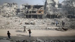 A Syrian army soldier walks past the rubble of damaged buildings in al-Hajar al-Aswad, Syria May 21, 2018. REUTERS/Omar Sanadiki