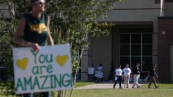 Community members stood in support as students and administrators returned for the first day of class since a deadly mass shooting in Santa Fe, Texas, U.S., May 29, 2018. REUTERS/Pu Ying Huang