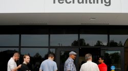 FILE PHOTO: Job seekers line up to apply during "Amazon Jobs Day," a job fair being held at 10 fulfillment centers across the United States aimed at filling more than 50,000 jobs, at the Amazon.com Fulfillment Center in Fall River, Massachusetts, U.S., August 2, 2017. REUTERS/Brian Snyder/File Photo