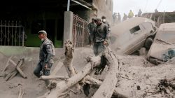 Policemen inspect at an area affected by the eruption of the Fuego volcano in the community of San Miguel Los Lotes in Escuintla, June 5, 2018. REUTERS/Luis Echeverria