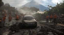 Workers remove ashes from a road at an area affected by the eruption of the Fuego volcano at El Rodeo in Escuintla, Guatemala June 6, 2018. REUTERS/Fabricio Alonzo