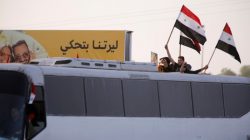 Syrian refugees who fled to Lebanon hold Syrian flags as they arrive at Syrian-Lebanese border of Jdaydet Yabous, Syria, April 18, 2018. REUTERS/Omar Sanadiki