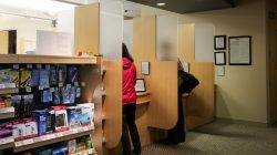 People speak with pharmacists at an internal pharmacy run by Walgreens at a Cisco health clinic at Cisco Systems in San Jose, California, U.S., March 22, 2018. Picture taken March 22, 2018. REUTERS/Elijah Nouvelage