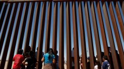 Children interact with members of the Presbyterian church in Sunland Park, U.S. at a new section of the border wall on the U.S.-Mexico border after a liturgy to commemorate the religious dimensions of migration, in this picture taken from Anapra neighborhood in Ciudad Juarez, Mexico May 3, 2018. REUTERS/Jose Luis Gonzalez