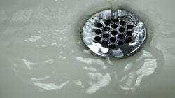 FILE PHOTO: Running tap water is seen in a city struggling with the effects of lead-poisoned drinking water, in Flint, Michigan, U.S., May 4, 2016. REUTERS/Carlos Barria/File Photo